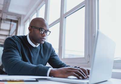 Man focused on laptop computer